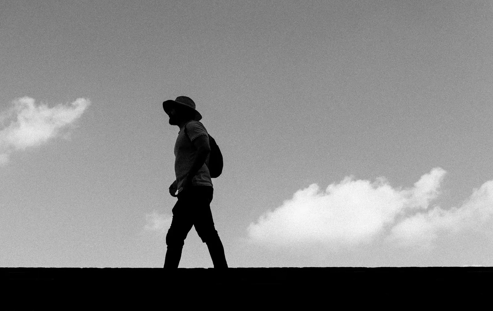 Silhouette of a man walking outdoors